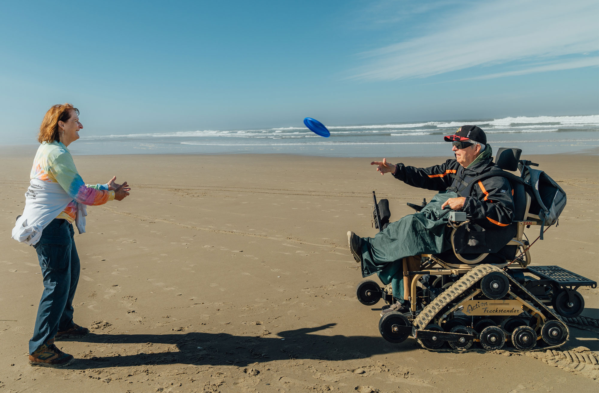 david chair beach couple frisbee