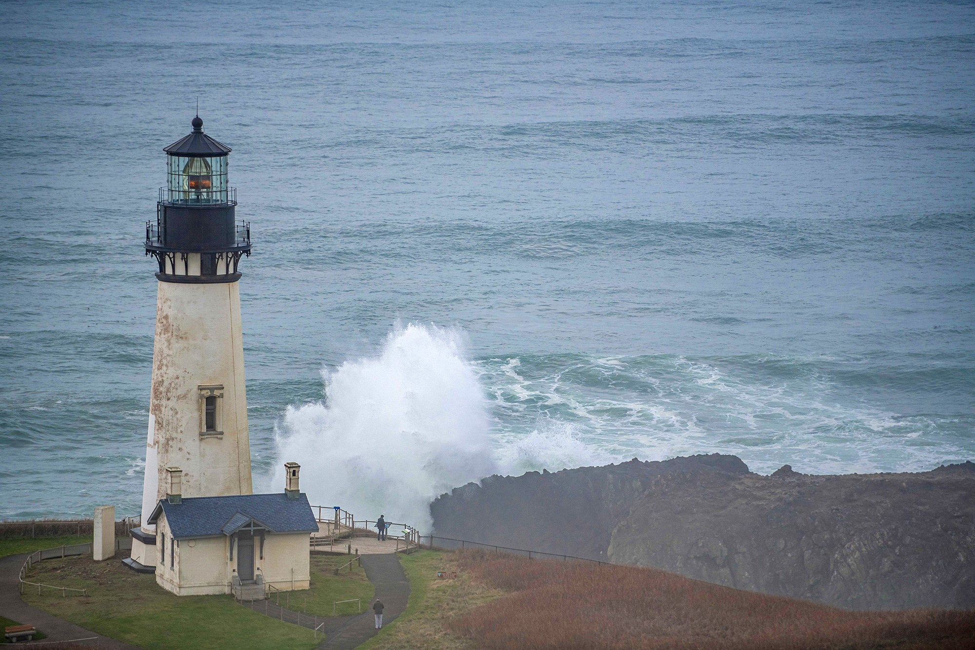 yaquina head lighthouse with wave newport oregon