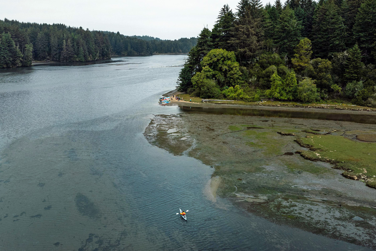 Aerial view of a kayaker in a wide slough.