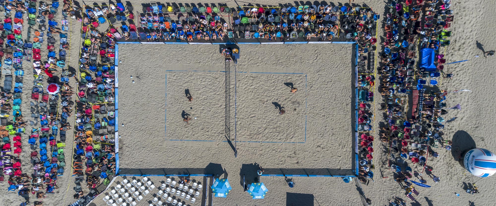 Overhead view of beach volleyball tournament.